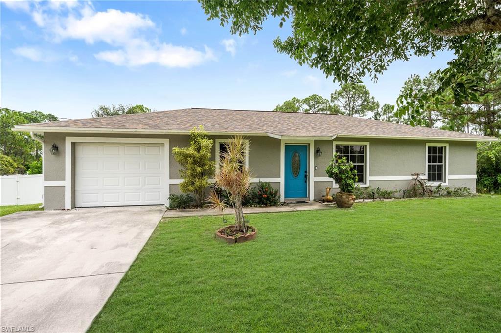 Affordable AND cute as a button! Take a look at this well maintained, 3 bedroom 2 bathroom home in Lehigh Acres. Feeling much larger than it is, this home is laid out perfectly to accommodate a family. Work from home? No problem! High speed internet is available in this area. The newer, vinyl wood-look flooring throughout the home is perfect for those with kids or furry pets. The oversized, half acre lot features a new privacy fence and is loaded with beautiful, mature oak trees. The roof was replaced in 2018, so you will save money on your homeowner's insurance. There's also an electrical plug installed, should you want to hook up a generator to keep your power going during a storm, should the electricity go out. Opportunity awaits, but not for long in this aggressive real estate market. Make a smart investment today!
