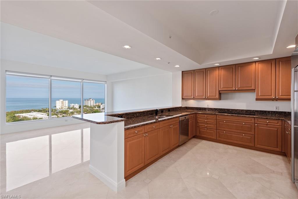Gorgeous high-floor views. Enter this spacious and popular four-bedroom, four-and-a-half-bath floor plan from your private foyer into an expansive living and entertaining space highlighted by floor-to-ceiling sliding glass doors, polished travertine tile flooring and an expansive screened-in lanai with electric roll-down hurricane protection. The kitchen design features a peninsula countertop with a separate breakfast table area. The spa-inspired master bath features an oversized shower, dual vanities and dual water closets. Your friends and family can enjoy maximum privacy in three spacious guest suites, all with en-suite baths. Trieste is planning upgrades to common areas and residents enjoy a geo-heated tropical pool, fitness room, social room, library and staffed front desk in the lobby. Experience Bay Colony and Pelican Bay beach clubs, with attended beach services or work on your serve at Bay Colony Tennis Club.