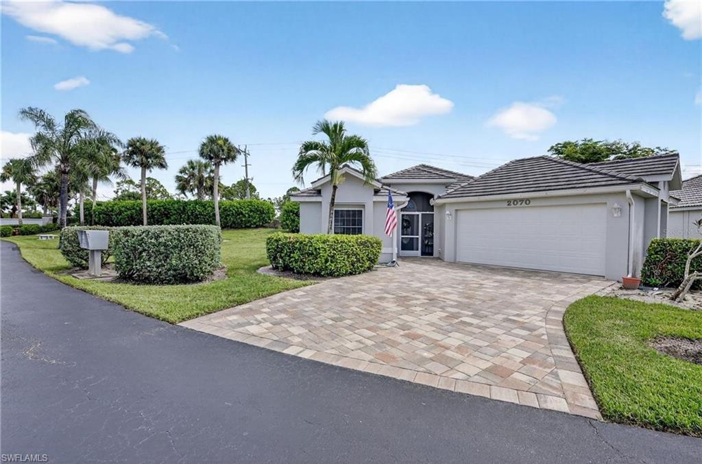 Hop in your golf cart and be at the Marina, boat docks, tennis, fitness, pickleball or golf course in minutes, with waterfront dining and Freedom Boat Club close by — everything you love about the Florida coastal lifestyle is right at your fingertips. Offered at $305,000, this beautifully maintained and fully furnished Outrigger model at 2070 King Tarpon Dr captures a relaxed beachy vibe throughout and delivers one of the best values in Burnt Store Marina and Golf. Burnt Store Marina is one of the largest, deep water Marina along Gulf Coast, with 525 Wet Slips with optional 27 Hole Public Golf Course with Pro-Shop. Major upgrades in this home are already complete, including a 2021 premium concrete tile roof, 2023 A/C, full hurricane-impact windows, storm-protected hurricane sliders, repiped plumbing, fresh interior and exterior paint, and gorgeous $22K Italian plank tile flooring that enhances the clean, airy coastal feel. The open living area features cathedral ceilings, recessed lighting, a TV with electric fireplace, and a bright dining space framed by triple bay windows. The entertaining kitchen includes newer stainless appliances, modern cabinetry, and two pantries. The primary suite offers French-door lanai access, updated dual vanities, and a beautifully updated walk-in shower, while the guest suite enjoys its own private wing. An extended under-truss screened lanai adds 200 sq ft of breezy outdoor living overlooking a lush greenbelt and privacy wall with no direct neighbors. Additional enhancements include gutters with leaf filters, a Kinetico whole-home water treatment system, new disposal, and a 50-gallon water heater. Located in FEMA Zone X with no lender-required flood insurance, this home also includes a Club Car 4-seater electric golf cart and two generators, making it an exceptional turnkey opportunity. With lawncare, pest care, cable, and WiFi included, low HOA fees, no CDD, and no major replacements needed, this home delivers effortless, affordable Florida living in a vibrant golf-cart-friendly community.