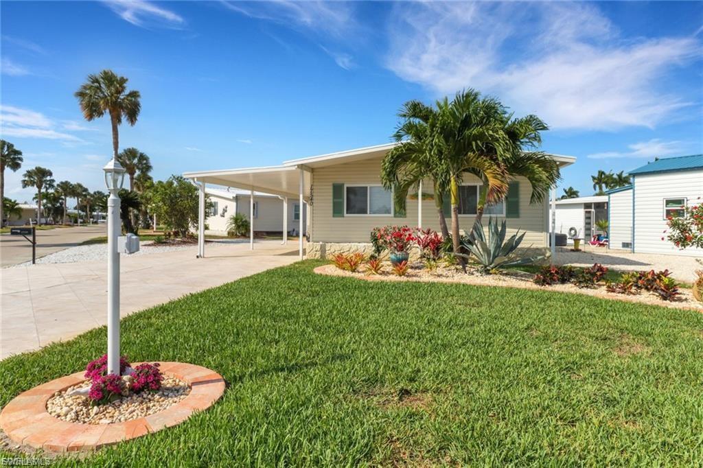 This beautifully remodeled Gulf-access home combines coastal elegance, modern upgrades, and exceptional outdoor living in one move-in-ready package. Offered with furnishings in a casual yet sophisticated coastal style, this meticulously maintained 2-bedroom, 2-bath residence features newer vinyl plank flooring throughout, newer shaker-style cabinetry, granite countertops, custom stone backsplash, stainless steel appliances, updated vanities, tiled showers, impact glass in the Florida room, and custom closet cabinetry in the guest bedroom. The thoughtfully designed kitchen includes a built-in desk overlooking the water — the perfect place to work, plan, or simply enjoy the peaceful canal views.

Major improvements include newer A/C with updated ductwork, mini split systems for enhanced comfort, a newer hot water heater, and maintenance contracts already in place for lawn care, pest control, and A/C servicing. The spacious Florida room and lanai create inviting indoor-outdoor living spaces ideal for relaxing or entertaining.

Situated on a large corner lot with lush mature tropical landscaping, the property also offers an extra-wide driveway with room for up to five vehicles, a spacious covered carport, and a detached outbuilding with additional storage, washer/dryer area, and extra screened entertaining space. Outdoor living truly shines with a large Trex dock, newer boat lift, kayak storage, and direct Gulf access for boating enthusiasts.

Located in the highly desirable Bayside Estates, a pet-friendly 55+ boating and golf cart community where you own the land, residents enjoy an active lifestyle with amenities including a community pool, pickleball, tennis courts, shuffleboard, bocce ball, activity center, and numerous social activities. Quarterly HOA fees of $700 include internet, lawn and land maintenance, water, sewer, and trash service.

Ideally positioned just 2.5 miles from Fort Myers Beach and minutes from Sanibel Island, this home offers convenient access to world-famous beaches, waterfront dining, entertainment, shopping, and the newly built Margaritaville resort. Move right in and enjoy the ultimate Southwest Florida lifestyle.