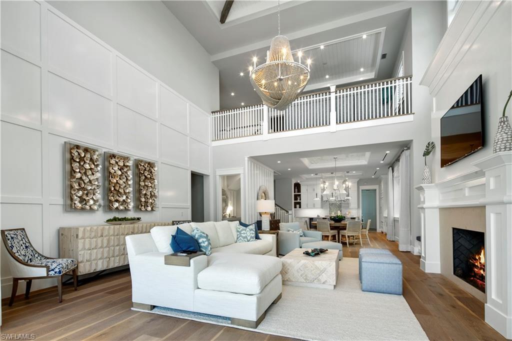 Luxuriously appointed & FURNISHED by Collins & Dupont Interiors, this Keewaydin III plan (Lot 27) offers a spacious 4 BD plus loft design, including private-entry guest cottage. PRIVATE BOAT SLIP INCLUDED & optional membership to the Naples Grande Golf Club. Wood flooring throughout, tongue & groove & stained beam ceiling treatments, gourmet kitchen with Wolf/Subzero appliances (including gas range) & an impressive 2-story ceiling in the living room with fireplace & custom built-in. Expansive covered outdoor terrace  w/ grilling station, outdoor fireplace & electronic screen & hurricane shutter protection. Tropical pool & spa area with wet wall feature and Shellstone decking surround. CBS construction,standing seam aluminum roof,natural gas feed & 19.5KW GENERATOR system. Mangrove Bay is nestled along the Gordon River in Old Naples & adjacent to Baker Park, the Naples Dog Park, 5th Avenue Shopping & Dining & the Gulf Beaches. Mangrove Bay offers a luxury resident Wellness Center with state-of the art- fitness room, resident lounge, ground level kayak/paddle board storage and private boat ramp.