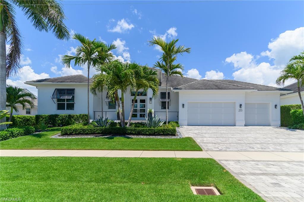 Come experience this coastal, luxury home, crafted with modern sophistication. Spanning 2,686 square feet under air (4,211 total under roof), this 4-bedroom, 3-bath home balances contemporary design with relaxed island living. The open-concept layout is filled with natural light, 10-foot sliding doors, volume ceilings, and finishes that makes the home live bigger than it is. You will enjoy the Viking appliances, sleek custom cabinetry, pantry, and an oversized island perfect for entertaining. The great room flows seamlessly to the outdoor living space complete with a summer kitchen, pool and spa. This home also comes with a 500-gallon propane tank, whole house generator, new A/C in 2023, new ice maker and dishwasher in 2024, new washer and dryer in 2025, and new pool pump in 2026. The primary suite is a true retreat with a large, walk-in shower, and designer details that make the home look brand new. Other features include steam shower and garage storage lift. This property has direct water access, and is located minutes away from Marco Island's beaches, and fine dining.