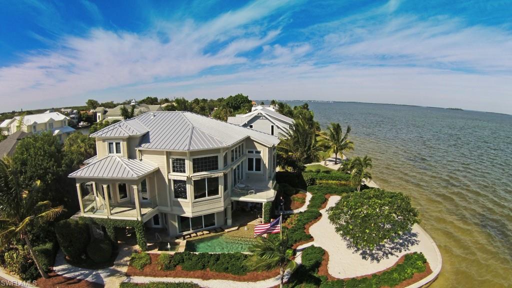 Premiere Bayfront property at the end of Isabel Drive features one of the islands most premiere residences. Custom constructed in 2009. Captivating panoramic view of San Carlos Bay. Private Beach. Custom on site Dockage, 10,000 remote control lift. Inviting sun kissed refreshing pool with creative water features and spa. Professionally landscaped yard. Enter the home and be awed! Water Views everywhere. As the sun sets…Fabulous dimming lighting fixtures and indirect cove illumination, wine cooler and soft music throughout. Beautiful cooks kitchen, handcrafted wood trimming, floors and ceiling. Square footage is from architectural, as built drawings. Many convenience features in addition to an elevator and automatic generator. For the most discriminating buyer.