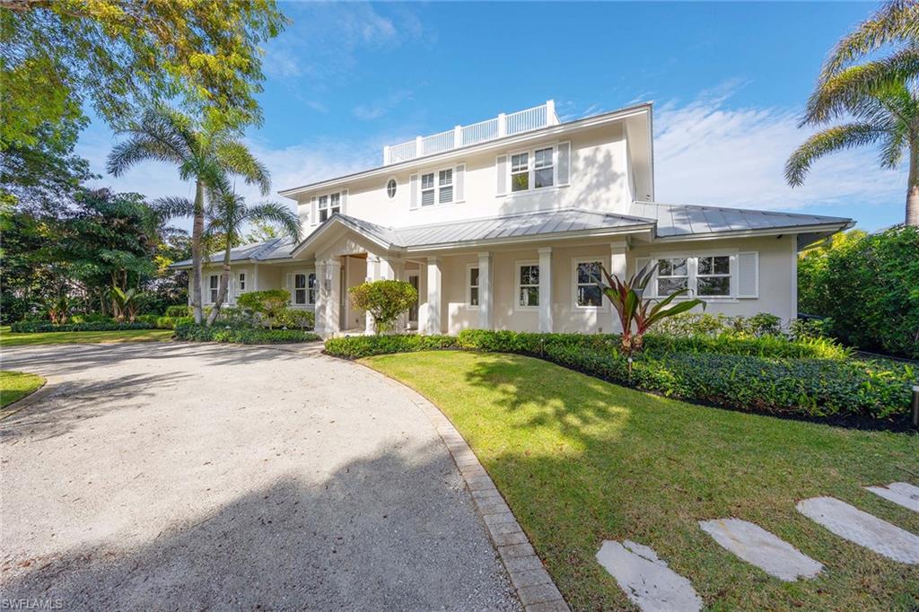 Experience the epitome of coastal luxury in this exquisite residence of five to six bedrooms and two living rooms on a tranquil, tree-lined street in walking distance to the pristine sands of Naples Beach. In the desired Ridge Lake neighborhood, this home is a testament to unparalleled craftsmanship and an unwavering commitment to the finest details. Indulge in culinary delights within the gourmet kitchen, a masterpiece of design and functionality. Display your vintages in the impressive glass wine room, a collector's haven. The expansive outdoor living space is an entertainer's dream, complete with electric roll-down screens and shutters. Pool deck allows for full sun all day. Built with uncompromising quality, this residence’s foundation has two stories of concrete block, and a poured concrete second floor in the X flood zone. Impact-resistant windows and doors, and a durable standing seam metal roof. The oversized garage will accommodate your vehicles, bikes, beach chairs and beach golf cart. This is the ideal home.
