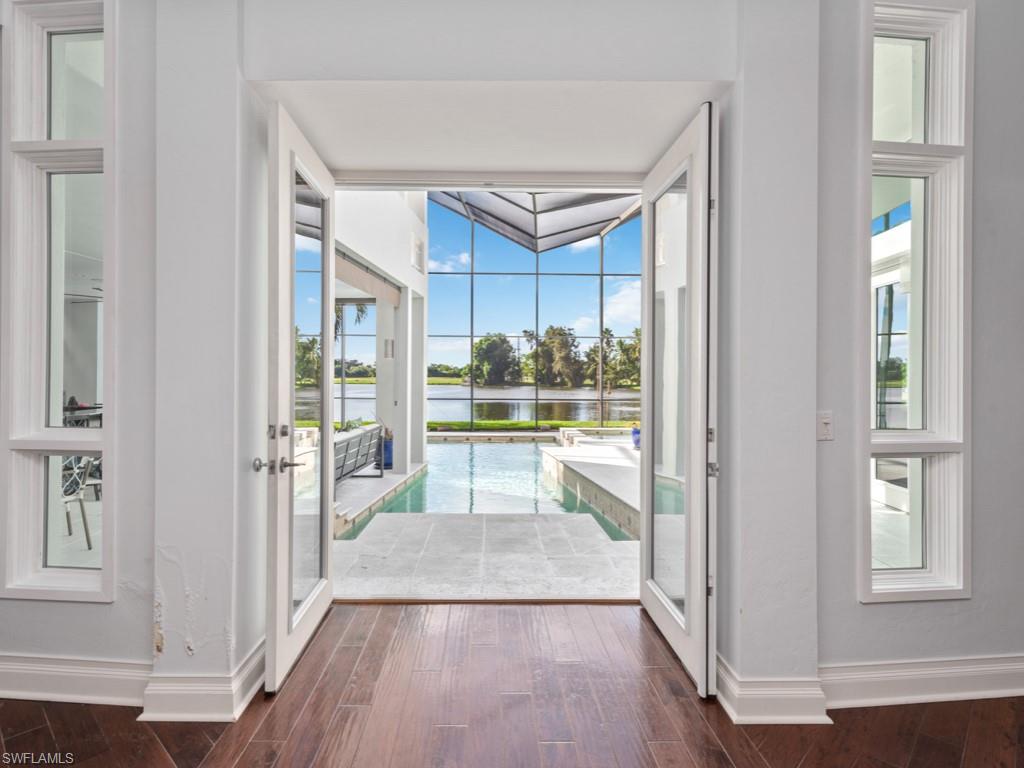 One of the best lots in Coquina Sands. This location has it all, oversize lot, southern rear, lakefront with golf course views, close to the beach and a short golf cart ride for shopping or dining on 5th and 3rd. Large contemporary home recently renovated with impact glass, designer kitchen and appliances, hand scraped wood floors, built-in cabinetry, large master closet, custom vaulted ceiling’s in master bedroom and main living area. Large bedrooms with private baths along with a half bath for guests. Additional master suite on second floor with deck looking out on Lake and golf course. Screened in outdoor sitting area with kitchen and bar. Custom pool, spa and dock by the lake for sunsets. Two car garage with extra storage area. Perfect home for family and entertaining. If you are thinking of a new build we have plans drawn for a 7500 square-foot residence on the property. This will save 10 to 12 months for drawings and can be delivered for 13,750 or bring your own builder. This is a must see home and lot.