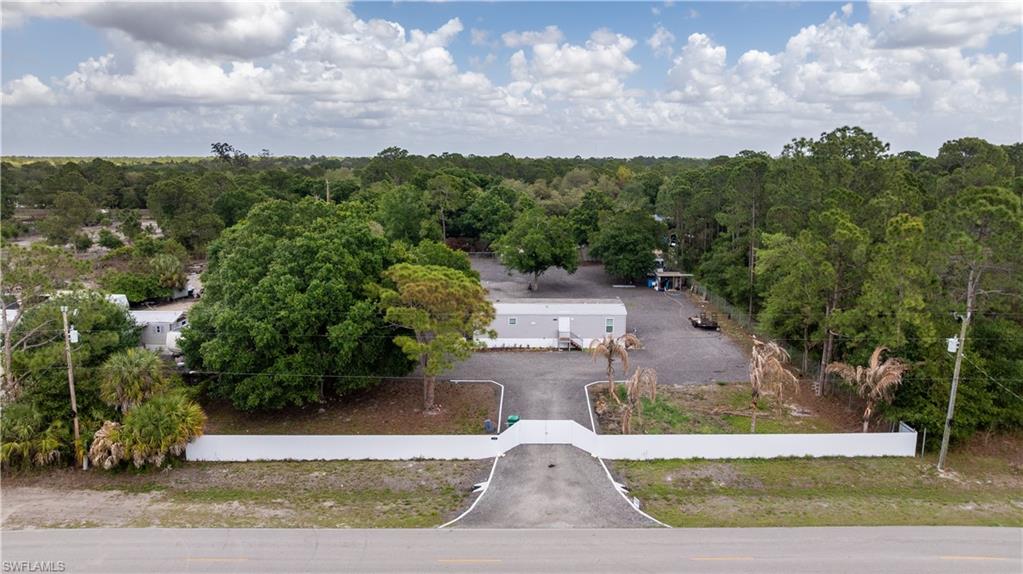 Shaded by mature oaks and set on over a fully fenced acre in the heart of Montura Ranch Estates, this like-new 2-bedroom, 1.5-bath home delivers the rural lifestyle you are searching for, at a price that makes sense. Built in 2022 and only recently occupied, it lives clean, fresh, and completely move-in ready.

The large covered deck creates a private outdoor retreat made for weekend cookouts, quiet mornings with a book, or evening gatherings with wine and friends. The entire property is fenced, with a metal privacy fence across the front of the lot, so you're ready for horses, goats, chickens, or whatever you're raising. The lot is cleared and ready for your toys, animals, or hosting fun family gatherings. Several mature oak trees offer the perfect shade to hang a hammock and soak in that peaceful countryside breeze.

Located on a primary street just down the road from the community mailbox kiosk and the clubhouse. You'll have quick access to amenities including a pool, basketball court, baseball and soccer fields, picnic areas, a playground, and an outdoor fitness space.

Clewiston is just 20 minutes away for dining, shopping, and Lake Okeechobee, known as the Bass Capital of the World. If adventure is more your speed, Skydive Spaceland is 10 minutes away, where you can take a skydive from 14,000 feet with jaw-dropping lake views. Prefer the beach? You're only about an hour from both coasts, with white-sand beaches, entertainment, and dining in either direction. Centrally located between I-75, I-95, RSW, and MIA makes traveling easy.

No HOA. A like-new home. A fully fenced-in acre. And one of the most unique rural communities in all of South Florida. Schedule your private showing today!