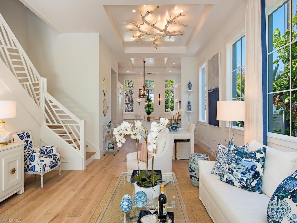 Located at 5th Avenue's edge, we proudly present Poinciana Cottages, a trio of much anticipated, rare new construction at Old Naples town center.  The South Cottage, at 460 6th Street S., is one of two remaining of the original trio. This stunning 3 bedroom + den, 3.5 bath residence revives the quintessential Old Naples cottage with a bold infusion of chic, casual elegance. High ceilings dominate the open floor plan bathed in abundant light. Thoughtfully appointed finishes include wide-plank flooring, selections of Calcutta marble, a fabulous La Canche French gas oven and white beamed ceiling treatments. Unique objects d'art inject a sense of playful design to the spaces by fusing the nostalgia of vintage architecture, with modern relevant design. The main level opens to a striking exterior living space paved in white decking and designed around the ambiance of a fireplace, water feature, pool and spa. Boasting an unrivaled location, this home is literally steps from the famed 5th Avenue district with its exciting mélange of dining, shopping, galleries and the crystalline beaches of The Gulf. This location presents your once in a lifetime opportunity to live in the heart of it all.