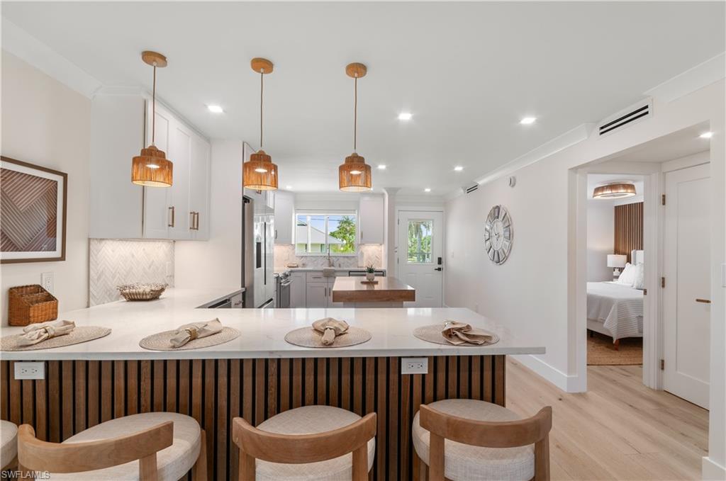 Experience refined waterfront living in this completely renovated second-floor residence in the highly sought-after Blue Point community of Oyster Bay. This exceptional 2-bedroom, 2-bath condominium offers tranquil canal and pool views in a peaceful, low-density waterfront setting just minutes from the world-class dining, shopping, and beaches of Olde Naples.
Designed for both relaxation and entertaining, the screened lanai provides the perfect setting for morning coffee, afternoon lunches, or evening cocktails while overlooking the water. Boating enthusiasts will appreciate community boat slips available for lease at only $300 annually, along with major community improvements including a brand-new seawall, dock, and roof completed in 2025.
No detail has been overlooked in the comprehensive renovation. The thoughtfully redesigned interior showcases Bosch gourmet stainless steel appliances, quartz countertops, custom cabinetry with under-cabinet lighting, a wine cooler, standalone ice maker, light oak hardwood flooring throughout, designer fixtures and hardware, new interior and exterior doors, recessed LED lighting, ceiling fans, Samsung televisions, Honeywell smart thermostat, Ring doorbell, and fully renovated bathrooms featuring custom shower enclosures and Toto automated toilets. The fully automated Zebra blind system allows effortless control of privacy and natural light with the touch of a button.
Offered 100% turnkey with all new furnishings included, this residence is truly move-in ready.
For investors, Blue Point offers outstanding flexibility with up to 12 rentals permitted annually and a 30-day minimum lease period, creating an exceptional opportunity for personal enjoyment, income potential, or both.
Ideally located in the prestigious Royal Harbor/Oyster Bay area, this property is poised to benefit from the continued transformation of the neighborhood, including the future Metropolitan Naples development at US-41 and Davis Boulevard. Rarely does a waterfront property of this quality, location, and value become available.