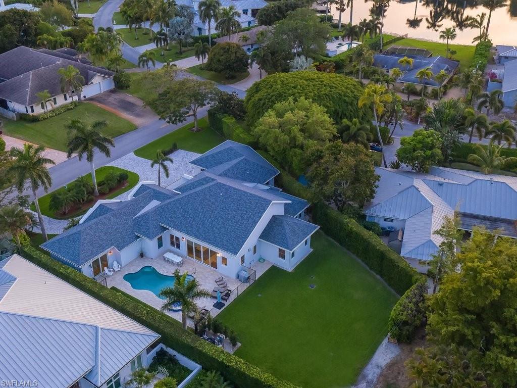 Now priced to SELL! Situated on .42 acres on a quiet street in the heart of Olde Naples, this gorgeous one-of-a-kind and recently remodeled 5 bedroom/5 bathroom home is move in ready. Just a short walk to the beach and 5th Ave S, the home features exquisite interior finishes with marble and Hickory flooring, imported custom cabinetry, handblown glass fixtures, and modern design throughout. Beautiful handcrafted architecture can be found throughout the home with soaring entry ceilings, coffered ceilings and Hickory wood accents.  Outdoor entertaining consists of an expansive backyard with new pool deck receiving sun for most of the day and accented with a relaxing spa. The private master retreat is completely separate from the rest of the home providing the ultimate in privacy.  The chef's kitchen features Quartzite counter-tops, Sub-Zero and Wolf appliances and an abundance of storage.  Residence is finished with a full 4.5-car, air conditioned garage, custom hand made mahogany front door, energy efficient Polaris gas water heater, and a buried 500 gallon propane tank for hot water heater and range.  Do not miss this rare opportunity!