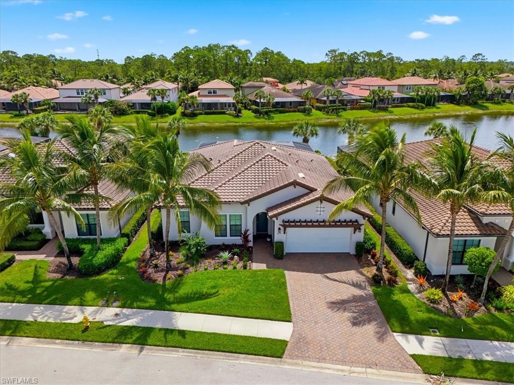 Welcome home to 4559 Tamarind Way in the highly sought-after gated community of Raffia Preserve. This impeccably maintained 3-bedroom + den, 2.5-bath home offers an exceptional lifestyle with peaceful lake views, a thoughtfully designed open floor plan, and an impressive list of recent upgrades. The spacious great room is the heart of the home, seamlessly connecting the living, dining, and kitchen areas, making it ideal for both everyday living and entertaining. Your chef-inspired kitchen features an oversized island, walk-in pantry, beautiful wood cabinetry, and quartz countertops. A private den with French doors provides the flexibility for a home office, media room, or guest retreat. Designed with both comfort and convenience in mind, this smart home is equipped with whole-home audio throughout the great room, lanai, primary suite, and primary bath, along with surround sound in the great room for an immersive entertainment experience. Lighting and ceiling fans are all automated throughout the home, while a Ring Pro security system with five cameras, cellular internet backup, and alarm backup offers added peace of mind. The MyQ smart garage door opener provides app-controlled access and supports Amazon Key in-garage delivery. Your spacious primary suite overlooks the tranquil lake and features a spa-inspired bath, creating the perfect private retreat. Step outside to your screened lanai where your private backyard oasis awaits. The heated pool has been enhanced with a saltwater conversion (2025), new variable-speed pool pump (2025), automatic pool fill system (2025), and an updated app-controlled pool automation system (2024), allowing you to manage your pool from anywhere. Whether you're entertaining guests or enjoying a quiet evening overlooking the water, this outdoor space is designed to be enjoyed year-round. Additional recent improvements include a new A/C compressor (2025), fresh interior paint (2024), all new ceiling fans (2024), and new professional landscaping (2025), making this home truly move-in ready. Residents of Raffia Preserve enjoy resort-style amenities including a clubhouse, community pool, fitness center, basketball court, playground, and scenic walking paths—all with low HOA fees and an ideal North Naples location close to top-rated schools, shopping, dining, and the world-renowned Gulf beaches. Every detail has been thoughtfully updated and meticulously maintained, creating a home that offers modern convenience, luxurious comfort, and the Naples lifestyle you've been waiting for.