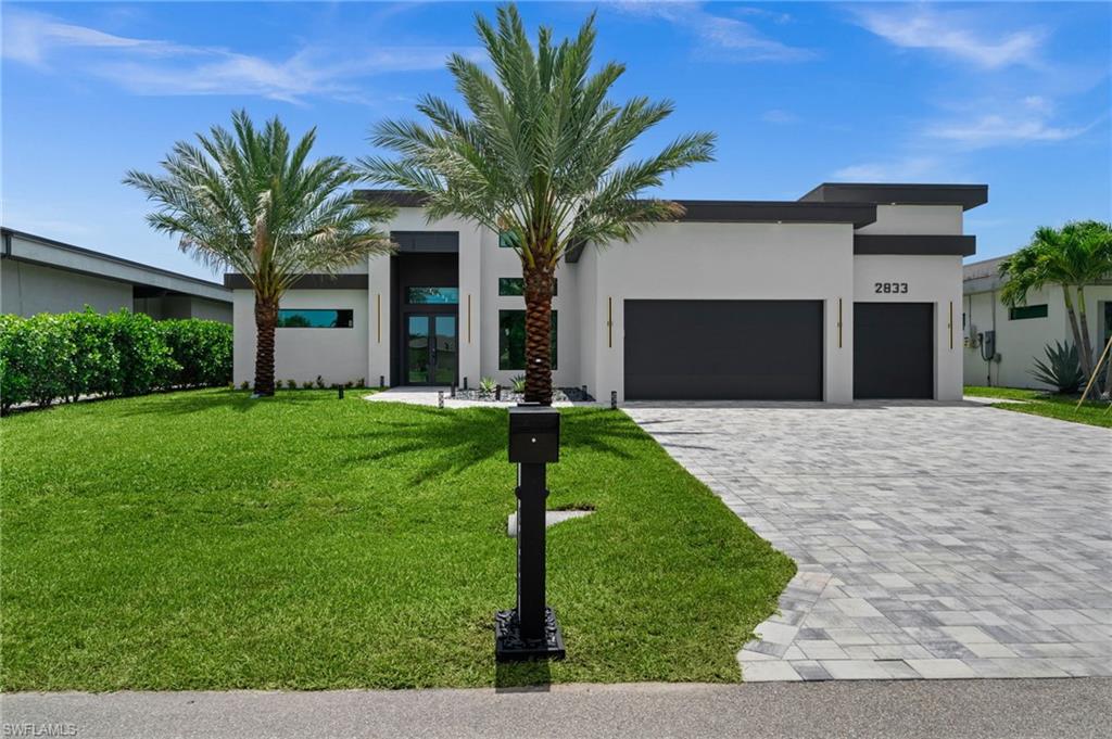 Experience luxury waterfront living in this stunning contemporary residence featuring 3 bedrooms, 3 bathrooms, and a versatile den. Designed with exceptional attention to detail, this home showcases high-end finishes throughout, including built-in panel-ready appliances, custom built-in closets and pantry, and state-of-the-art smart home technology.

The spacious living room serves as the heart of the home, featuring a sleek built-in vapor fireplace and TV, creating an inviting atmosphere for both relaxation and entertaining. Integrated speakers in every bathroom add a touch of luxury and enhance the home's modern appeal.

The primary suite offers a true spa experience with an oversized soaking tub and a luxurious shower with body jets, each bathroom equipped with a speaker

Enjoy seamless indoor-outdoor living with a resort-style pool and spa, along with a fully equipped outdoor kitchen featuring a built-in BBQ grill with an integrated griddle and outdoor TV—perfect for entertaining year-round.

Additional highlights include a 3-car garage, spray foam roof insulation for enhanced energy efficiency, and Gulf access for boating enthusiasts. Located in a quiet, desirable neighborhood, this exceptional property perfectly blends contemporary design, luxury finishes, and premier waterfront living.