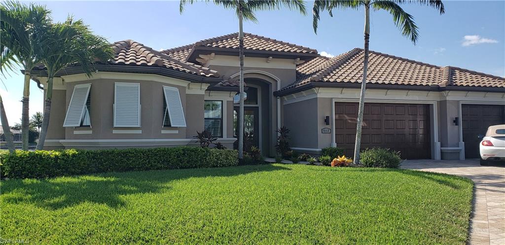 Unparalleled view with 330 feet of lake frontage on Wazee Lake!! This gorgeous listing located in NW Cape Coral.   A 3 bedroom 3 bath home with den on the lake. Home is protected by impact glass with the exception of dining area window which has shutters. Spacious great room offers crown molding, shaker style cabinetry, granite counters, stainless appliances and open corner sliders with unimpeded view of outdoor living space and lake beyond. Owner’s suite offers large bedroom with tray ceiling  and en-suite bath with dual vanities, walk through shower and jetted tub. Each secondary bedroom has it’s own bath with roomy showers and feature plantation shutters. Lanai living space includes outdoor kitchen, infinity edge pool, spa, roll down hurricane screen and plenty of room to entertain. Waters edge showcases 100’ of composite captain’s walk, 14,000 pound covered boat lift, lighting and water. The trip to Matlacha Pass takes just 20 minutes. Hoot septic system and whole house R/O for water. What an amazing place to call home!