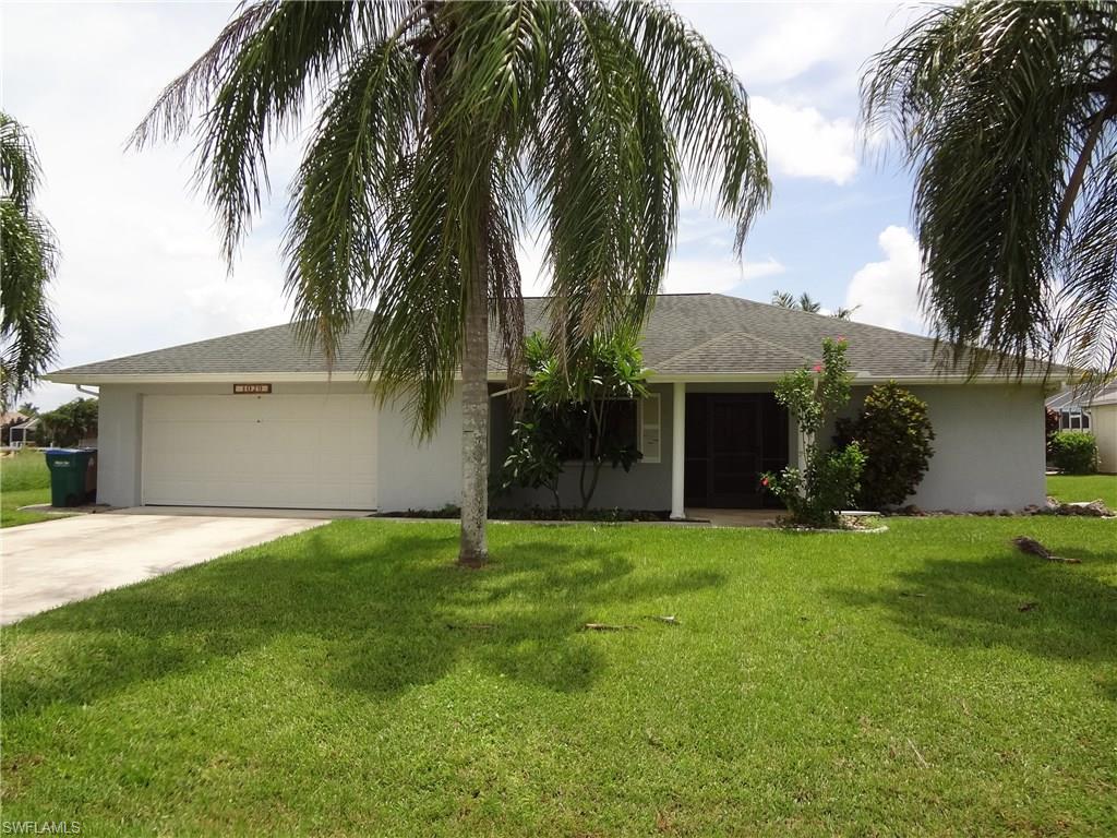 GULF ACCESS HOME-PRICED TO SELL!!! No boat locks to got through, and ASSESSMENTS ARE ALL PAID! GREAT LOCATION! Nice floor plan with CATHEDRAL CEILING, 'split' bedrooms, ALL WALK-IN CLOSETS in bedrooms, enclosed Florida Room with a wall of sliders the ENTIRE length of the room, large SCREENED LANAI, 'pocket' sliders', & guest bath with access to outside. Plenty of room to add pool! Large, diagonally laid TILE floors throughout! Kitchen has GRANITE tops, pass-thru window, breakfast bar, pantry, & newer dishwasher! Recent interior paint, newer water heater & some ceiling fans. Oversized garage auto door opener, & room for extra storage! Large concrete BOAT DOCK, plus LIFT! Fenced area for the pets! Accordion & roll-down (manual) STORM SHUTTERS! Dimensional shingle roof. Tropical landscaping with concrete curbing & sprinkler system!  Screened double door entry. HURRY, WON'T LAST AT THIS PRICE!