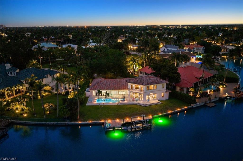 Boasting no bridge access to the Gulf, coveted southern exposure, and nearly half an acre of waterfront property, 350 Bow Line Bend presents an exceptional opportunity to enjoy today while envisioning and designing your future dream residence. Nestled along a quiet, private enclave within the Moorings, Bow Line Bend is gracefully lined with mature live oak trees, creating a naturally lush and picturesque setting. With over 150 feet of water frontage overlooking the tranquil waters of Moorings Bay, the property offers an extraordinary canvas for creating a private coastal retreat tailored to your lifestyle. Expansive outdoor living possibilities, stunning water views, and the serenity of the bay combine to deliver the quintessential Naples waterfront experience. Boating enthusiasts will appreciate the effortless Gulf access, ideal for spontaneous days on the water, while evenings are best enjoyed beneath vibrant sunset skies from the comfort of your own backyard oasis. Residents are also eligible to join the Moorings Beach Association, offering access to private beachfront parking and one of Naples’ most coveted beach amenities.
