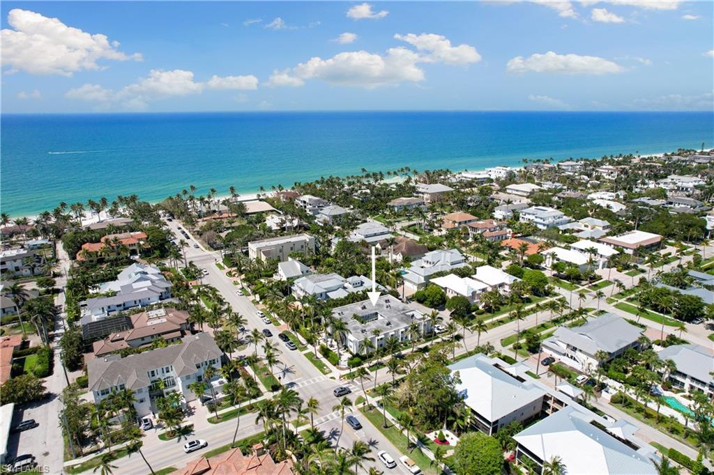 Introducing Sunset Paradise - a premier 2-bedroom, 2-bath condo in the heart of downtown Naples, offering 7-day minimum rentals for excellent income potential. Located just a stone's throw from the stunning 5th Avenue S. beach, this luxurious retreat includes everything you need from linens to beach chairs. This dream destination is surrounded by upscale boutiques, fine art galleries, and gourmet dining options.
The open-concept living room boasts elegant furnishings and tasteful artwork, fostering a relaxing atmosphere for entertainment and leisure. The thoughtfully designed layout provides ample space for you and your guests to unwind after a sun-soaked day exploring the nearby sandy shores.
Indulge in the fully-equipped kitchen, outfitted with stainless steel appliances, custom cabinetry, and quartz countertops. An array of kitchen amenities ensures effortless meal preparation, whether you're enjoying a leisurely breakfast or preparing dinner. The two well-appointed bedrooms offer a sanctuary, complete with plush bedding and ample storage. One BR features an en-suite bathroom, while the second BR has access to a full bathroom ensuring privacy and convenience for all occupants.