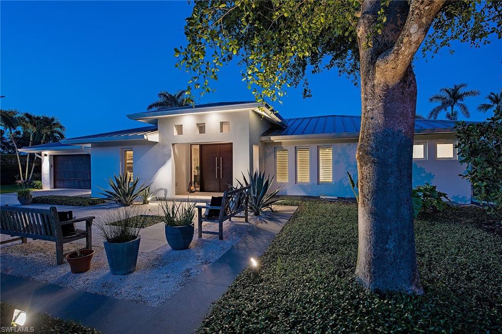 Tropical ambiance is abundant in this one-of-a-kind, "magazine-worthy" custom home situated on a generously-sized .57-acre lot. Completely remastered in 2014 featuring numerous upgrades including spectacular custom lighting, sophisticated architectural features and a truly gourmet kitchen - to name a few. The smartly designed contemporary interior melds seamlessly with expansive views of the pristine pool area and the property's idyllic landscaping, expertly designed by Ed Westwood with GardenBleu. Mature trees and secluded outdoor sitting areas further enhance the feeling of total privacy. This home has the added advantage of separate but attached guest quarters that could also be used as a home office or studio. Move-in ready, this rare offering is the perfect blend of contemporary style with true Old Naples charm.