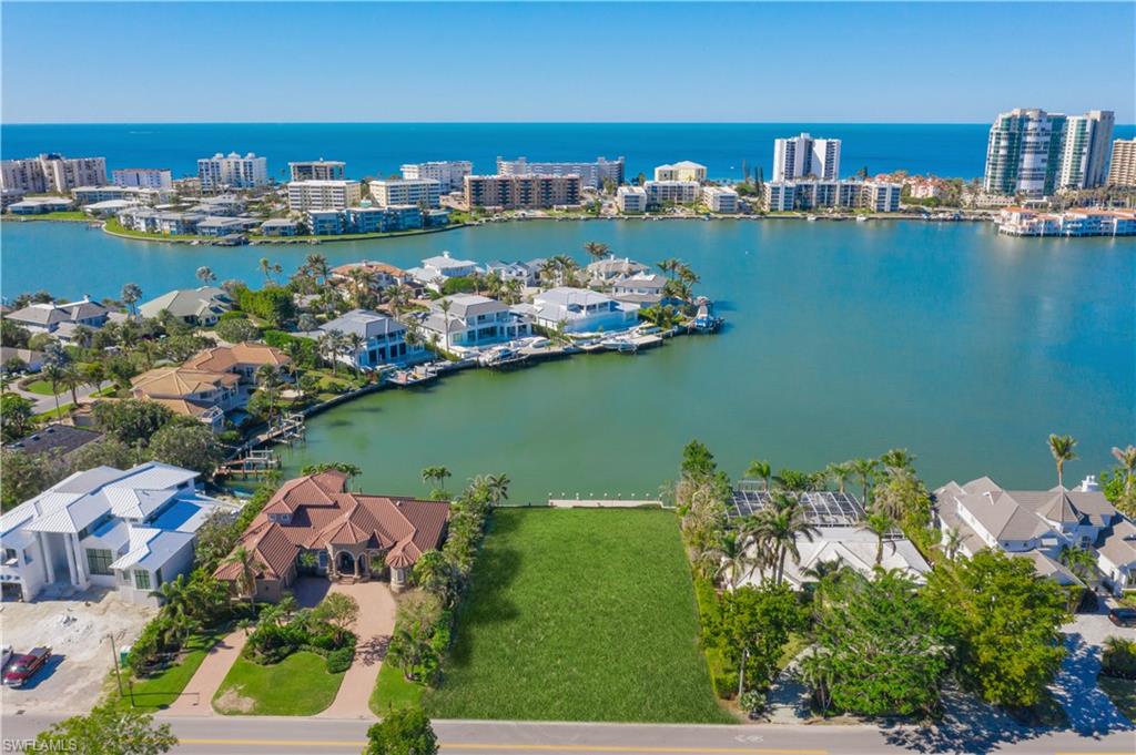 Over 100 ft of waterfront and highly sought after western exposure, this homesite offers endless sunsets and expansive bay views.  The extra depth of this property offers the ability to build a sprawling first level floorplan with amazing pool and outdoor living space, just waiting to be conceptualized.  Enjoy the Moorings with a voluntary beach club membership, easy access to downtown or north Naples and calm, no wake waters, perfect for casual boat cruises or peaceful paddleboard rides.