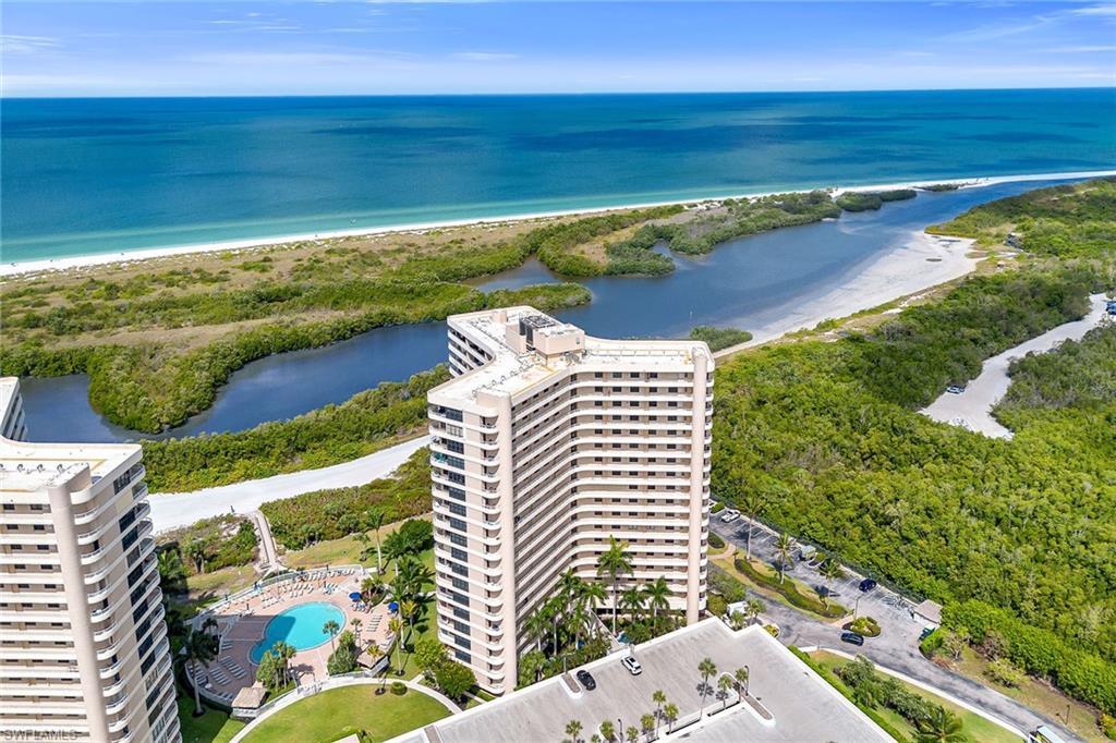 Experience coastal living with desired beach access and breathtaking western exposure that delivers unforgettable sunset views over the Gulf each evening. This beautifully maintained residence offers an inviting blend of comfort and convenience in one of Marco Island’s desirable waterfront communities, where resort-style amenities and a prime location create the ideal island retreat, seasonal getaway or investment opportunity. Boat slips are also available for lease in the community, offering added convenience for boating enthusiasts. The thoughtfully designed floor plan features two bedrooms and two baths. Inside, tile flooring flows throughout the main living areas, complemented by bright natural lighting that enhances the open and airy atmosphere. The living room seamlessly connects to the covered lanai through sliding glass doors, creating an ideal indoor-outdoor lifestyle ideal for enjoying coastal breezes and spectacular sunset skies. Impact-resistant doors and windows provide valuable storm protection and peace of mind. The kitchen is functional and stylish, featuring recessed lighting, custom cabinetry, a pantry, and a breakfast bar counter ideal for casual dining and entertaining. Appliances include an electric range, dishwasher, and refrigerator/freezer with icemaker. The dining spaces are thoughtfully integrated with the kitchen and living areas, offering flexibility for everyday meals or hosting guests. The primary bedroom is filled with natural light and showcases luxury vinyl flooring, a ceiling fan, custom mirrors and sliding glass doors leading directly to the lanai for a tranquil private retreat. The en-suite bath includes a glass walk-in shower and tub combination. The guest bedroom also features luxury vinyl flooring and a ceiling fan, while the hallway guest bath offers a matching glass walk-in shower and tub combination. Residents enjoy an impressive collection of amenities including a community pool and spa, direct beach access, tennis and pickleball courts, an exercise room and more. Whether relaxing on the sand, enjoying island recreation or taking in nightly sunsets from the comfort of home, this exceptional Marco Island residence captures the best of Southwest Florida living. This turnkey property offers a strong rental history, making it an excellent investment opportunity with weekly rentals allowed.