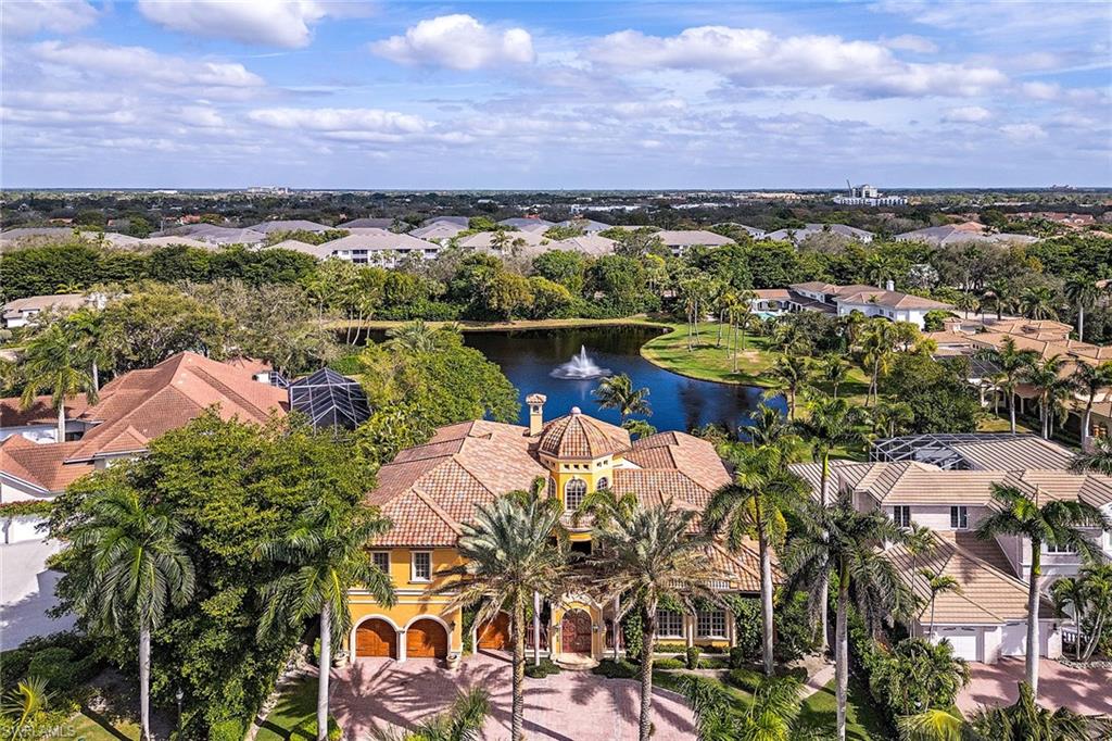 In the exclusive guard-gated community of Bay Colony. Enjoy the private beach club, exceptional dining, full beach service and private tennis club. Considered a BCB masterpiece, this exceptional home brings entertaining to a new level with the gourmet kitchen, walk-in wine cave and butler's pantry. Incredible expansive ceilings and exquisite details are found in every room. There is a massive wood entry door, koi pond, vaulted game room and indoor-outdoor living boasting a massive fireplace. Stunning outdoor screened lanai overlooking the lake. Primary living on the first level with guest privacy on the second. Steps from world-class Ritz-Carlton, Naples’ finest shops and fine dining. Enjoy all Pelican Bay amenities. Two beach restaurants, beach service, dining and beverages while enjoying the sunny days and sunsets at night. This unique lifestyle is in one of the most desirable residential seaside communities in Naples!