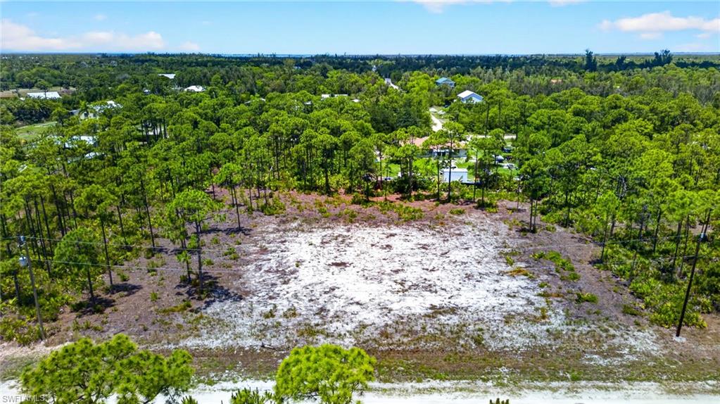 Rare Double-Lot Oasis! Cleared 1-Acre Parcel in Desirable Bokeelia – Ready for Your Dream Island Home! Escape to the tranquil paradise of Pine Island and build your ultimate retreat on this massive 1-acre cleared lot. While most standard parcels in the peaceful Kreamer’s Avocado subdivision are just a half-acre, this rare property offers double the size, giving you an incredible whole acre of pure potential. The grueling and expensive site preparation is already done for you. The lot has been meticulously cleared, and stumps have been completely removed, saving you thousands of dollars in upfront excavation costs, heavy machinery rentals, and months of waiting on contractors. It is a clean slate, 100% ready for your architectural blueprints. Situated on the highly sought-after north end of Pine Island in Bokeelia, this location perfectly balances secluded "Old Florida" charm with convenient modern amenities. Enjoy a relaxed, golf-cart-friendly island lifestyle surrounded by lush palm nurseries, tropical fruit groves, and vibrant local art culture. You are just minutes away from world-class tarpon fishing, multiple local marinas, public boat ramps, local boutiques and stunning waterfront dining landmarks like the historic Tarpon Lodge. When you need a taste of the city, Cape Coral is just a short, scenic 20-minute drive away. Electricity and water available in the immediate area. No HOA and the property is NOT in a flood zone!
