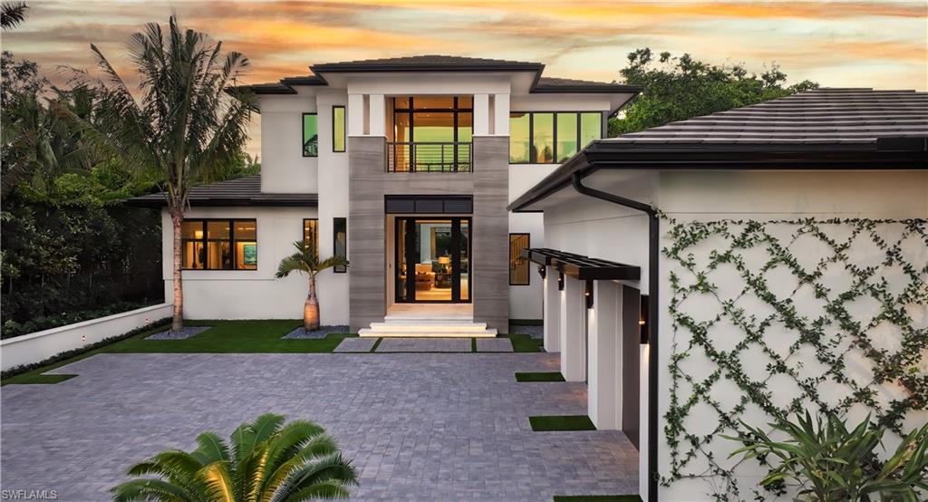 London Bay Homes and Romanza Interior Design have combined their extensive experience of over 25 years in designing and building homes together to create a truly remarkable opportunity. The first floor features an expansive great room, dining area, and café seating, complete with a custom Poliform kitchen and a fully equipped prep kitchen. You can take the stairs or private elevator to the second floor, where you'll find a lounge, morning bar, and two spacious bedroom suites, all with access to a balcony that overlooks the spectacular rear yard. Step outside to discover a true oasis, featuring a resort-style pool and spa, along with over 1,700 square feet of covered outdoor entertaining spaces. This includes a well-equipped outdoor kitchen with an L-shaped bar and an Evo grill. A separate covered outdoor dining pavilion, situated under a canopy of coconut palm trees, overlooks the pool and tropical landscape. Additionally, a cabana and outdoor living room at the rear of the property includes a fireplace, TV, appliances, and roll-down screens and shutters. Meticulously crafted, this home strikes a perfect balance of refined sophistication and practical elegance. Ideally located just a block from the beach and close to downtown shopping and dining, it promises an enviable lifestyle.