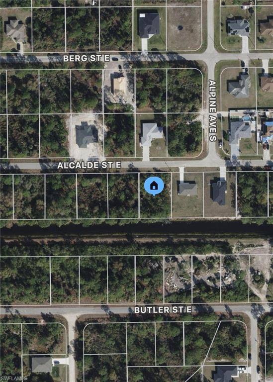 Vacant lot with a paved road with power pole at the curb - on a canal with Southern facing exposure! Call today for more information. Hablo español!