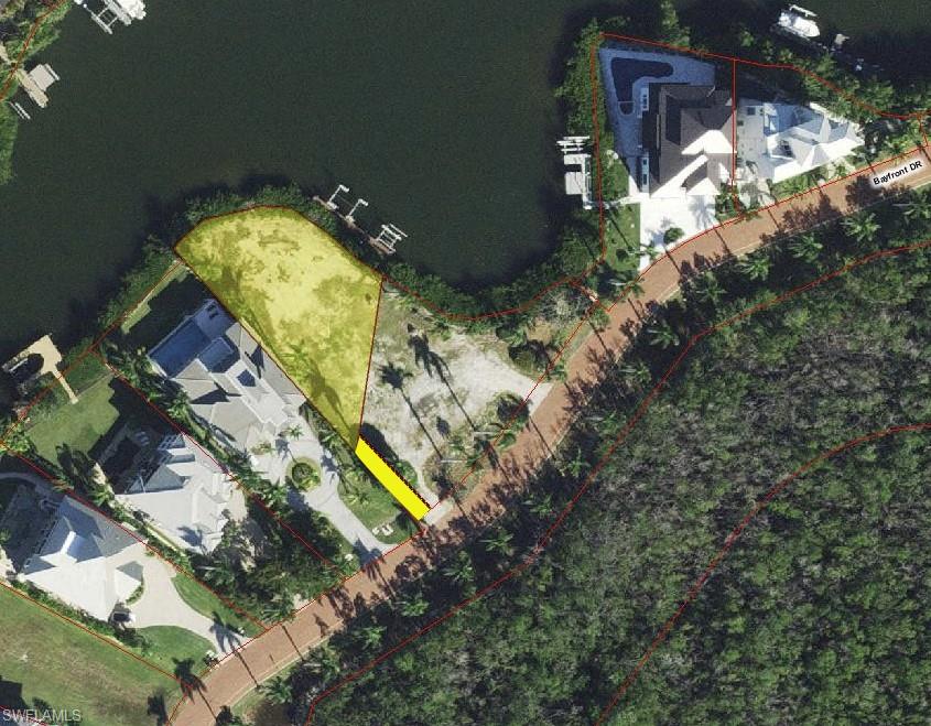 This large bayfront lot is located in the double gated Bayfront Gardens and within the beautiful community of Barefoot Beach. This lot features 172’ of waterfront, is the ultimate location to build your 3 or 4 story luxury waterfront home and will provide wide water views plus there are no homes across the street - just a beautiful nature preserve. The lot is 11,545SQ FT (.265 acres) and all utilities are available. A double boat dock with lift and double jet ski lift/jet boat lift are in place (Buyer to provide any required upgrades or modifications) will provide a short ride to the Gulf of Mexico with no bridges. And best of all - it is just a short walk to the white sandy beaches of Barefoot Beach via one of two private beach accesses for use by Bayfront Gardens residents. A recent survey is available with all setbacks indicated and will show the dedicated 12’x60’ driveway access easement providing a private entry to this property. Barefoot Beach is one of Collier Counties most desirable Beach to Bay communities and includes one of the highest ranked beaches in the country, 24 hour guard patrols, manned guard gate, and the option to join the fantastic Club at Barefoot Beach including its full service attendants at the beach and pool, casual and fine dining, a busy event calendar, tennis with pro and more. Put a deposit for a membership when purchasing the lot and the wait list should be over when your house is finished plus you will have limited usage during the wait.