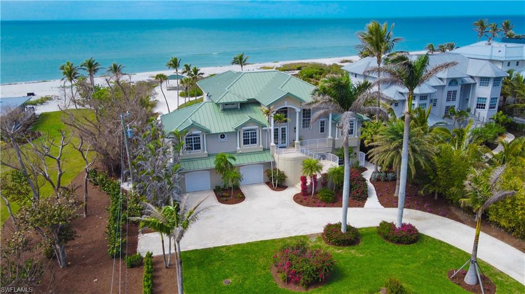 This meticulously refined Gulf-front estate embodies the essence of tropical luxury—where timeless craftsmanship meets modern elegance. Thoughtfully enhanced over time, SOUTH HAVEN blends comfort, sophistication, and functionality at every turn. Recent updates include a redesigned kitchen and dining area, a reimagined primary bath, and a new roof (2023), along with premium finishes and fixtures throughout. The main level welcomes you with a sun-filled foyer leading to multiple guest suites, including a dual guest wing for added privacy. The chef-inspired kitchen combines contemporary design with coastal warmth, opening to a bright dining alcove ideal for gatherings. The living room frames uninterrupted Gulf views, creating a serene backdrop for every moment. Upstairs, the owner’s suite commands sweeping ocean vistas and features a stone-clad electric fireplace, woven flooring, and a tranquil, spa-like ambiance. The ground level includes a spacious garage, flexible-use spaces, and elevator access to all floors for effortless convenience. Outdoors, the estate is graced by towering Royal Palms, a resort-style pool with sun shelf, and covered lounging and dining areas designed for relaxed entertaining. Beyond the pool, a private beachside yard with manicured greens, a seaside walkway, and a charming shorefront cabana completes the coastal experience. From its refined architecture to its breathtaking sunsets, South Haven stands as a true Captiva masterpiece—where every detail celebrates the art of island living.