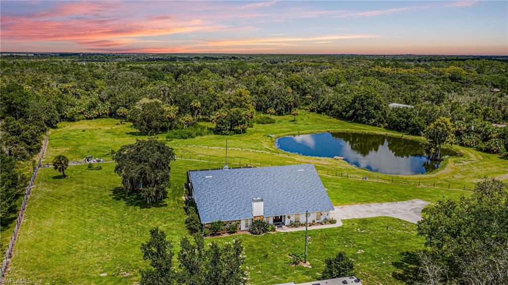 Welcome to the best of both worlds in exclusive Prairie Creek Estates. This magnificent 2 story custom pool home has been completely renovated. Its 5+ acres offers tranquil and private country living yet only 20 minutes to Charlotte Harbor and historic downtown Punta Gorda. The property offers a split paddock, naturally stocked pond as well as backyard access to captivating Prairie Creek. The elegant chef's kitchen boasts a luxurious island, stone countertops, stainless appliances and panoramic views of the property. Both formal living room and grand family room express a warm invitation with stone covered wood burning fireplaces. This 5 bedroom plus bonus room home is comprised of 4 bedroom suites with the main oversized master bedroom on the first floor. The billiards room located on the second floor overlooks the family room with double sliders that invite you to your peaceful screened in pool. This is a must-see estate.