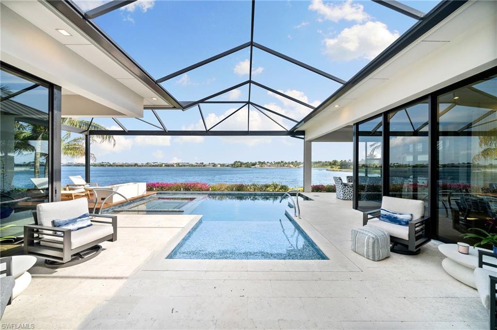 Elegance and luxury at its best awaits in this hidden gem. This private one of a kind turnkey furnished home is located on one of the most prestigious streets in Naples Reserve—with rights to build a boat dock behind your property. Stunning views from the largest lake in Naples Reserve. Layout in your lanai, and have total privacy from your neighbors. This house is situated to have direct Lake views with no obstructions and a Grandview of the largest lake in Naples Reserve. Every detail of this home has been masterly crafted by one of Naples most prestigious builders. The interior has been carefully custom designed with over $500k in Clive Daniels wallpaper, furniture, and pictures. Enjoy watching the sunrise by your fire pit located in the center of the pool on your lanai.