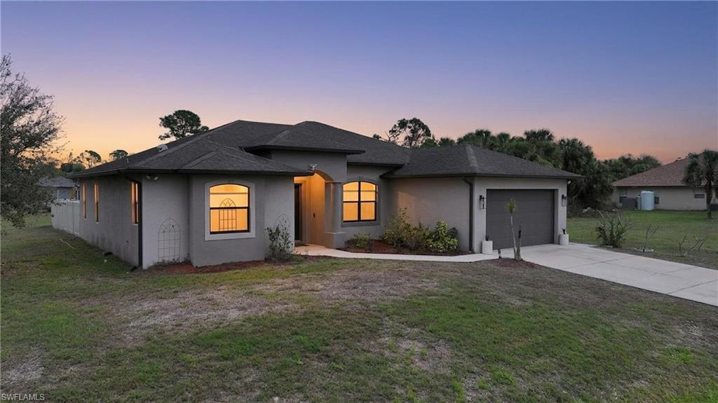 Welcome to this beautifully maintained 3-bedroom, 2-bathroom home situated on a desirable corner lot in a quiet, peaceful neighborhood in the heart of North Port, Florida. Built in 2016, this residence offers the perfect blend of modern living and Florida charm—with upgrades that set it apart from the typical cookie-cutter home. Located in a NON-FLOOD ZONE for added peace of mind, this property is a rare find in today’s market. Step inside to an open-concept layout featuring soaring ceilings and a split-bedroom floor plan designed for both comfort and privacy. The spacious kitchen showcases granite countertops, custom tile work, high-end wood cabinetry, modern appliances, and a separate pantry—perfect for everyday living and entertaining. The primary suite offers a relaxing retreat with a private en-suite bath, while the additional bedrooms share a convenient Jack-and-Jill bathroom, ideal for families. This home is loaded with thoughtful upgrades, including impact glass throughout, custom fixtures, no carpet for easy maintenance, and a full home water treatment system. Step outside and enjoy a fully fenced backyard complete with an irrigation system to keep your landscaping lush, plus a full-blown playground—perfect for kids to play while pets roam safely. There’s also a bonus enclosed lanai or flex space ideal for a playroom, gym, or additional living area. Additional highlights include a two-car garage, ample driveway parking, and convenient access to shopping, schools, parks, and I-75. Whether you're a first-time buyer, growing family, or seasonal resident, this move-in-ready home truly stands out from the rest.