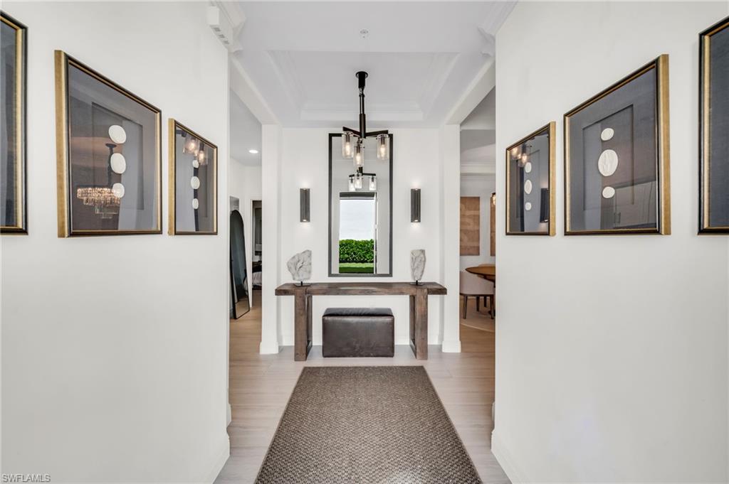 Welcome to a beautiful newer first floor coach home located in the HEART of Talis Park built in 2023.  Viansa neighborhood is centrally located in Talis Park.  A modern private setting.  This three-bedroom, two bath residence features an open great room layout with large sliding large sliding doors that extend the living space to a screened lanai with southern exposure allowing for lots of natural light.  The kitchen includes island, quartz countertops, premium cabinetry, and stainless-steel appliances.  The primary suite provides lanai access, dual walk-in closets, and attached garage, soaring 9 ft ceilings, impact resistant windows and doors, and private building entry.  Restoration furniture and decor throughout are negotiable. Living in Talis means access to world class amenities.  The Centerpiece, the Vyne House clubhouse offers elegant and casual dining.  The Core fitness center, Espirit Spa, Fiona's Market cafe and vibrant community events.  For more relaxed entertainment, Casa Cortese provides a full-service sports pub with billiards, darts, ping pong, shuffleboard, and a state-of-the-art trackman golf simulator. Golf enthusiasts will appreciate the 18 -hole Greg Noman & Pete Dye Championship course, ranked among Florida's top 20 by Golf Digest. Beyond golf residents enjoy a sports complex with tennis, pickleball, bocce, dog park, scenic walking paths, a resort style pool, lap pool, kids' playground, and Beach runner shuttle to Vanderbilt Beach, complete with towels, chairs, and refreshments. Talis Park is conveniently located just 20 minutes from RSW Airport. This home provides the Naples lifestyle with privacy.