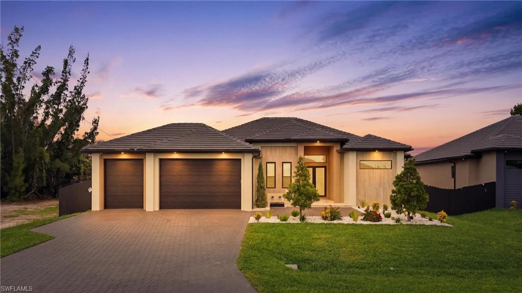 Experience luxury living at its finest in this stunning modern residence located at 422 SW 31st Ave in one of Cape Coral's fastest-growing areas. Perfectly positioned just minutes from the highly anticipated Seven Islands development, this exceptional 4-bedroom, 3-bathroom home with a spacious 3-car garage offers the perfect blend of elegance, comfort, and convenience.
From the moment you arrive, the striking curb appeal sets the tone. A beautiful waterfall fountain welcomes you home, while the tile roof and contemporary architecture create a sophisticated first impression. Inside, soaring high ceilings and an open-concept design provide a bright, airy atmosphere filled with natural light.
Every detail has been thoughtfully designed, featuring custom cabinetry throughout the entire home, offering both style and functionality. The luxurious owner's suite serves as a private retreat, complete with custom-built his-and-hers closets and a spa-inspired bathroom featuring a fully integrated steam shower for the ultimate relaxation experience.
The heart of the home seamlessly flows to the outdoor living space, where you'll find an expansive covered lanai designed for entertaining year-round. The fully equipped summer kitchen includes a cooktop, beer dispenser, and ice machine, making it effortless to host family and friends. Beyond the lanai, the resort-style pool and spa create a true backyard oasis, offering the perfect place to unwind and enjoy Southwest Florida living.
Meticulously maintained and completely move-in ready, this home delivers the luxury lifestyle you've been searching for. Whether you're relaxing by the pool, entertaining guests outdoors, or enjoying the nearby shopping, dining, boating, and future attractions of the Seven Islands project, this remarkable property is ready for you to call it home.
