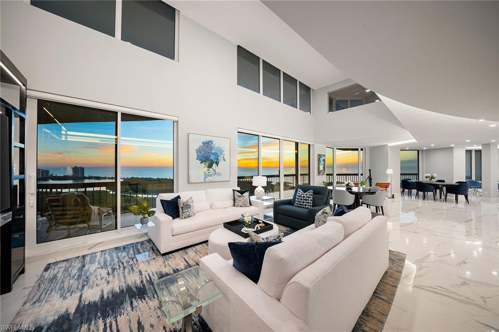 Exceptional value for this rare, one-of-a-kind two-story penthouse spanning the entire Gulf-facing side of the building with direct, unobstructed panoramic views among the most breathtaking in Naples. Offering over 5,500 square feet, this four-bedroom plus den, four-bath residence lives like a home in the sky with expansive living areas, loft and over 1,000 square feet of wraparound lanai space. Remastered in 2023 with a reimagined floor plan, to-the-studs chef’s kitchen, expanded wet bar, walk-in pantry, enlarged laundry and designer finishes. Main level includes a bedroom suite, den and powder room. Floor-to-ceiling impact glass, custom closets, Hunter Douglas remote shades and two secure parking spaces. Offered turnkey furnished. Near the Pelican Bay berm and tram, the second closest building to private South Beach. Near Waterside Shops, dining and Artis-Naples. Enjoy membership at Pelican Bay’s private beachfront dining, attended beach service, fitness center, tennis, pickleball, kayaking, biking and miles of scenic paths. Central to Old Naples, Mercato and RSW.