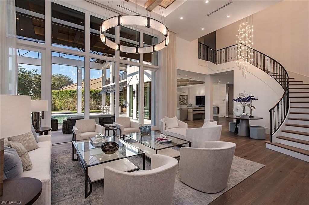 An “architectural masterpiece” in the heart of Bay Colony. The absolute finest specifications, long lake views, impeccable interior, incredible furnishings, and creative finishes in this estate home. Encompassing 6,925 square feet/9,399 square feet total. Two private garages offer four spaces. Soaring custom ceilings, light airy great room open to the family room, culinary kitchen and butler’s pantry. Expansive screened pool setting complete with delightful outdoor living area. Five full-bedroom suites. The master enjoys dual baths, separate walk-in closets, and custom built-ins along with a tranquil fireplace. A cabana suite on the master level, three additional suites on the upper level, open media room shared by all guests. Charming covered outdoor terrace overlooking the pool, lake view with private elevator to the spacious upper living. Residents enjoy a world-class setting, and seaside guard-gated community inclusive of a private beach club and tennis club along with all of Pelican Bay amenities. Initially constructed in 1999, this estate home has been rebuilt by BCB Homes featuring the “best of the best,” completed November 2022.