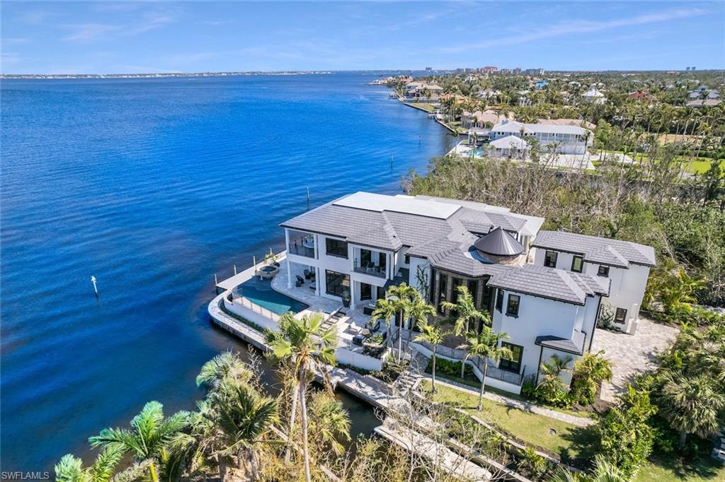 Waterfront Luxury Living like no other in SWFL. A one-of-a-kind estate home featuring gorgeous water views from every vantage point. Recently enhanced & totally recreated from top to bottom, inside and out, this amazing home comes completely & lavishly furnished. As you enter the home, you are blown away by a breathtaking walnut staircase & exquisite hand blown glass chandeliers. The flow of the home is so inviting & exciting all the way through. The expansive great room, dining area & gorgeous chef’s kitchen acts as living space while being able to enjoy incredible water & sunset views. The home features a private guest suite accessed from the portico walkway or from a separate garage below. The highlights are endless w/special features like a spacious billiards/media room, 3 car garage, an elevator, wine cellar, accordion pocket sliding doors, incredible quality, custom cabinetry & counter tops. The outdoor living space is private & peaceful w/a negative edge pool & spa, lots of open & covered deck space, fire pit area, dog walk, & multiple docking areas for all your water craft needs. This home will “WOW” you w/ detail, features, space, privacy, views & comfort.