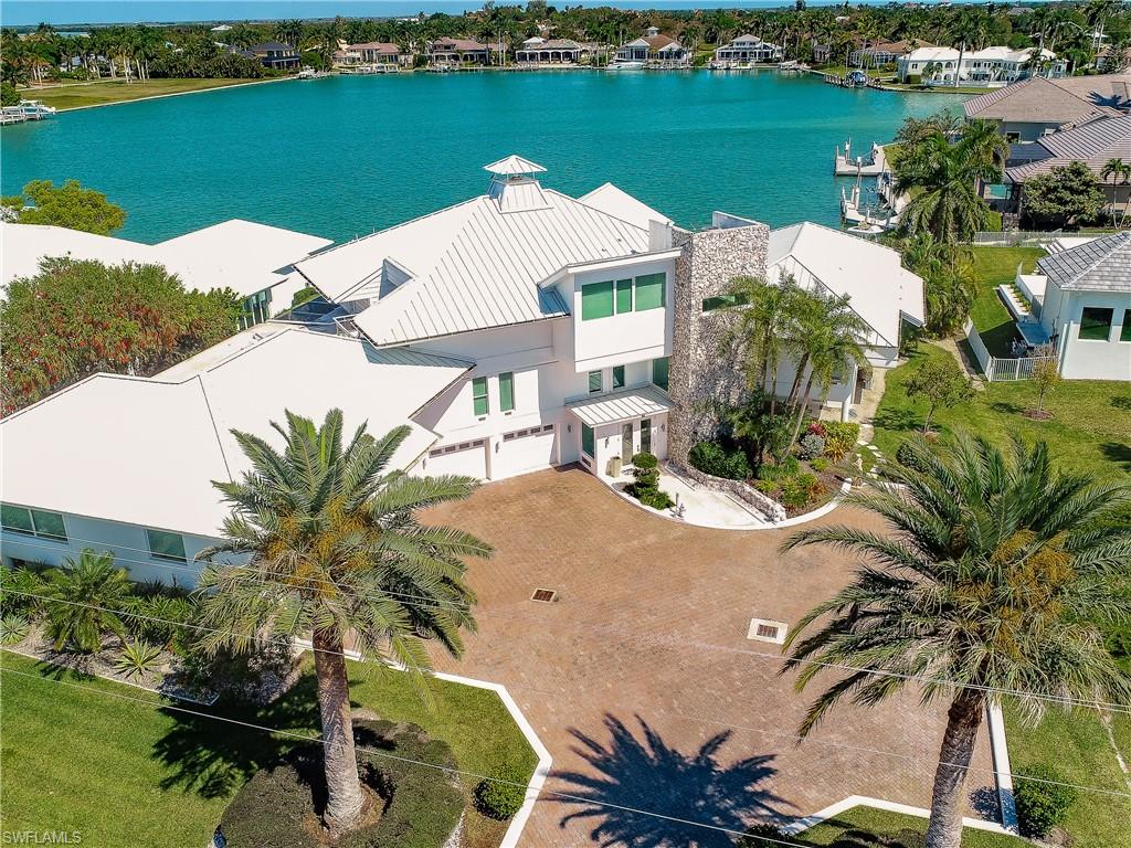 LOCATION..LOCATION...LOCATION. This contemporary, estate is located on quiet Fredrick's Bay with a unobstructed bay view. The Miami Vice style property was designed to capture the ultimate bay views where you can enjoy seeing the dolphins and manatees throughout the day. The house has been updated and remodeled in the last 5 years. It features a new roof, new kitchen, new bathrooms, new a/c systems and all impact windows and doors. It has an upper level sanctuary for guests with the most stunning views. The property also features a custom built fireplace, air conditioned boat storage, two boat lifts and a large patio terrace for outdoor entertainment. This is one of a kind, unique and inspiring masterpiece of construction.