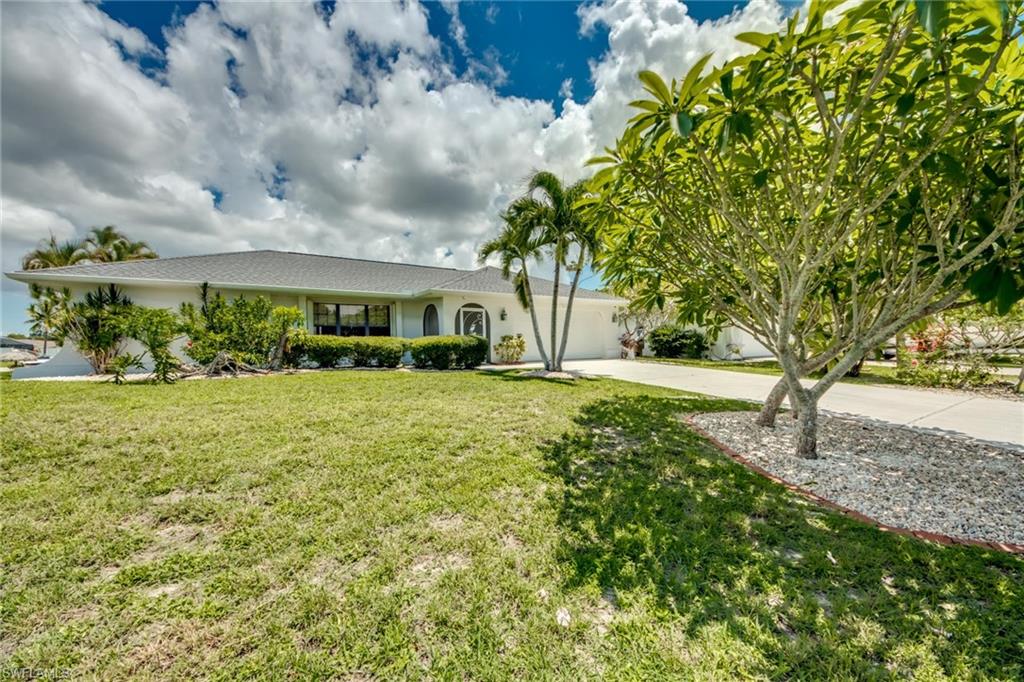 LOCATION!LOCATION!LOCATION! New Roof! Gulf access with just one bridge out and minutes to the River. You do not want to miss this lovely home with intersecting canal views! Pull  up into the drive and you will know you are in Paradise when you see the beautiful Plumeria blooming in the front yard. This home is spacious with three bedrooms on a split plan, an open living and dining area and a great room with an indoor laundry!  A large screened lania is private and the pass through window so you can easily serve your guests. There are roll down and accordian hurricane shutters to make closing up after season a breeze. Assessments paid. Freshly painted and ready for you!