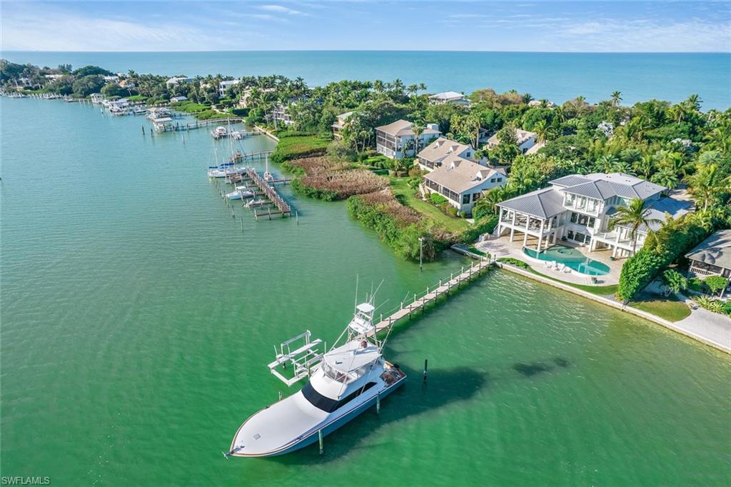 This fantastic waterfront residence is an immaculate Show Case of luxury with Panoramic Bay views. A one-of-a-kind design by John Cooney of Naples. The Property is tucked away for maximum privacy. Stunning lush tropical grounds with a circular driveway that meets an expansive staircase to your tropical oasis. Step into paradise as you enter the large foyer & experience this perfectly designed “Island Style" home as your eyes meet the deep blue and turquoise view of the Bay. Featuring expansive windows to maximize the stunning Bay views from the great room with coffered ceiling & soft colors throughout. Perfect for entertaining
family & friends. A large veranda overlooks the Bay, private dock & custom pool with infinity spa. Luxurious master suite features a loft, sitting room, wet bar & a gorgeous master bath with glass steam shower, soaking tub & walk-in closet. There is a view from almost every corner of this exquisite structure. Steps to the beach & sunsets from your own deeded beach access.