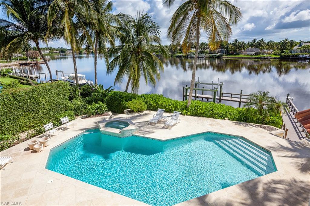 H.12042 Enjoy breathtaking views of Treasure Cove from this architectural masterpiece designed by renowned architect Kasimir Korybut.  The quality workmanship of A Vernon Allen Builder, Inc. ensures that no detail was overlooked. Recently updated kitchen features huge island, breakfast bar and gas stove.  Home is an entertainer’s dream with glass enclosed bonus room overlooking an over-sized pool complete with boat dock and boat lift. Second floor master retreat boasts water views, large walk-in closet, gorgeous shower with multiple shower heads and soaking tub.  Other recent improvements include roof, dock, impact doors and impact windows! Panoramic water views and comfortable living come together in this elegant residence complete with Port Royal Club membership eligibility!