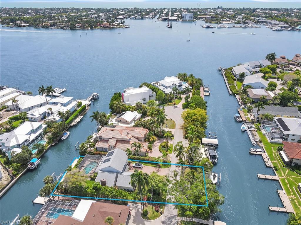 Discover an exceptional waterfront retreat in the highly desirable location of Oyster Bay. This unique property offers a total of 160 feet of water frontage, 80 ft on the southern side and 80 feet on the northern side with two private boat docks, two lifts and bridge free access to Naples Bay and Gordon Pass- ideal for avid boaters and adventure seekers. This coastal charmer offers a perfect blend of timeless style, updated interior and open living spaces perfect for entertaining. Stunning water views and endless sunrises and sunsets with preferred southern exposure. This home has been meticulously maintained throughout the years making it an ideal full time/part time residence or an incredible opportunity for redevelopment. Enjoy close proximity to Downtown Naples, world class dining, shopping and beaches.