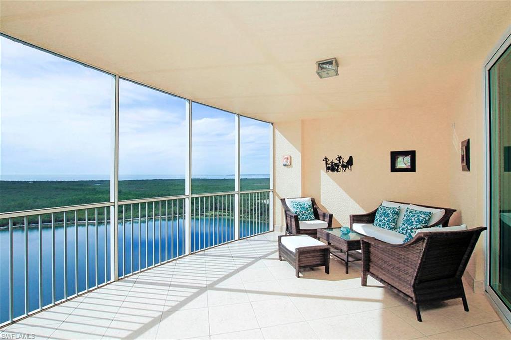 Calming describes this corner sky-home. An elevator lifts you to a private foyer leading to a spacious, bright great rm w/wall of glass & solar shades. A 400+ sq ft outdoor living space allows more entertainment options.Breathtaking describes the view-crystal clear lake, acres of preserve & sparkling waters of the Gulf & Bay.2426 sq ft of interior space includes: living/dining area; kit. w/solid surface, island & bar w/granite, eat-in area w/lots of light. Master BDRM w/wood floors, access to lanai & panoramic views. Master BA w/2 windows letting in sunlight, 2 vanities, walk-in shower w/ handheld shower head, soaking tub & water closet w/beadboard. Huge Master Closet! Private en-suite for guests. 3rd BDRM/Office has custom built-ins including desk w/granite top, extra storage & Murphy BD. A 3rd BA adjacent to Office. Laundry w/deep sink.Crown molding in every rm. Upgraded lighting throughout. Under the BLDG, enclosed 2-car garage w/ epoxy floor. 5-Star amenities. PRIME location.