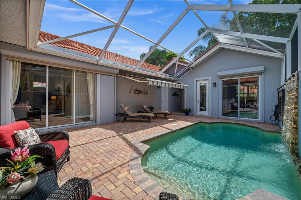 This beautifully updated 3 bedroom, 3 bath pool home in the World Tennis Center, offers a private resort-style setting in one of Naples’ most convenient locations—just minutes from white-sand Gulf beaches, Waterside Shops, Mercato, downtown Naples, exceptional dining, shopping, and cultural attractions. At the heart of the property, a sparkling pool with a dramatic waterfall feature creates a tranquil focal point, while the surrounding brick-paver courtyard provides multiple spaces for lounging, dining, and entertaining in complete privacy. A detached cabana suite—complete with its own bedroom and full bath—offers exceptional flexibility for guests, extended family, a home office, or private retreat. Inside, the light-filled living room, anchored by a striking electric fireplace, flows effortlessly into the kitchen and dining areas. The kitchen is thoughtfully appointed with stainless steel appliances, rich granite countertops, abundant cabinetry, a breakfast bar, and an adjacent dining space. Wood-style flooring, volume ceilings, and walls of glass overlooking the courtyard enhance the home’s warm yet refined atmosphere. The spacious primary suite offers direct access to the courtyard and pool area, while the en-suite bath features dual vanities, a soaking tub, and a separate shower. A generous guest suite within the main residence provides additional comfort and privacy for family and visitors alike with its own bath. Beyond the courtyard, an open brick-paver patio off the dining area creates yet another inviting outdoor gathering space.
Residents of World Tennis Center enjoy an exceptional amenity package centered around its renowned tennis facilities, including multiple Har-Tru courts, professional instruction, league play, and an active social calendar. Additional amenities include a resort-style pool and spa, clubhouse, fitness center, pickleball, basketball, walking paths, and beautifully landscaped grounds. Combining privacy, flexibility, and a coveted central Naples location, this distinctive courtyard home offers an outstanding opportunity to enjoy the Southwest Florida lifestyle at its finest.