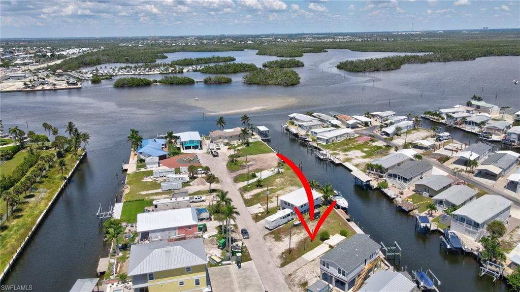 Build your dream home on this lot within walking and biking distance to Ft. Myers Beach, Margaritaville, restaurants, shops and everything you want to live the Florida lifestyle.   Park your boat at this waterfront lot which has fast access to the Gulf.