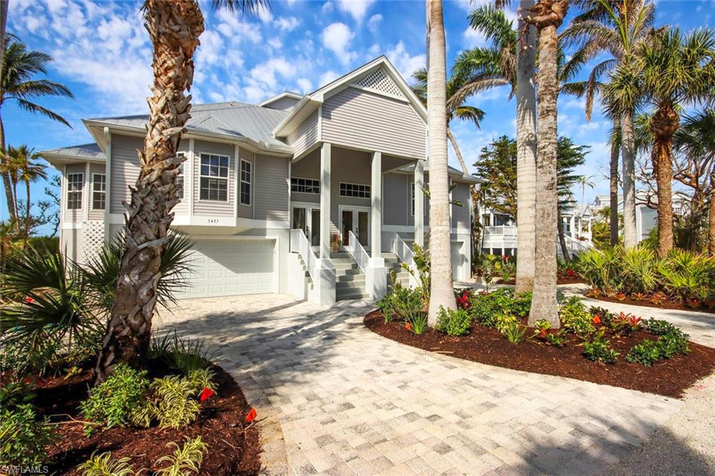This one will make you smile . . . Experience island living in this exceptional, fully furnished residence offering breathtaking views of Clam Bayou and the Gulf of Mexico. This impeccably maintained home features two levels of beautifully designed living space, including a screened lanai, open sun porch, and expansive west-facing deck — perfect for enjoying sunsets. Turnkey-ready, this 3-bedroom, 2.5 bathroom home includes an elevator servicing all floors, including the top-level primary suite. The main level is centered around a great room with vaulted ceilings and floor-to-ceiling windows that frame bayou views. A custom kitchen opens into the dining and living areas, creating a warm, open-concept flow. Two spacious guest suites offer the flexibility of a den or office conversion to meet your lifestyle needs. The upper level is dedicated to the primary suite, complete with his-and-hers closets and a spa-style bathroom. Additional highlights include a generous two-car garage, with ample storage. Located in close proximity to Bowman's Beach, J.N. “Ding” Darling National Wildlife Refuge, and Captiva Island.