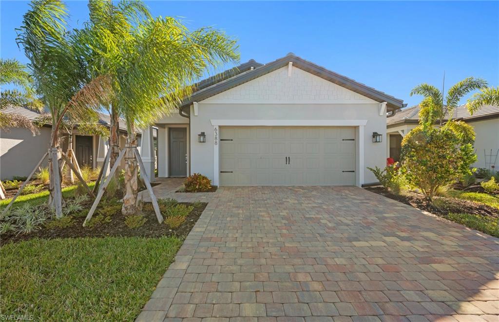 Move to Del Webb - Naples now! This lovely Hallmark has an Enclosed Flex Room, Pocket sliding glass doors in the gathering room, Tile throughout the whole house, Upgraded kitchen countertops, and much more.