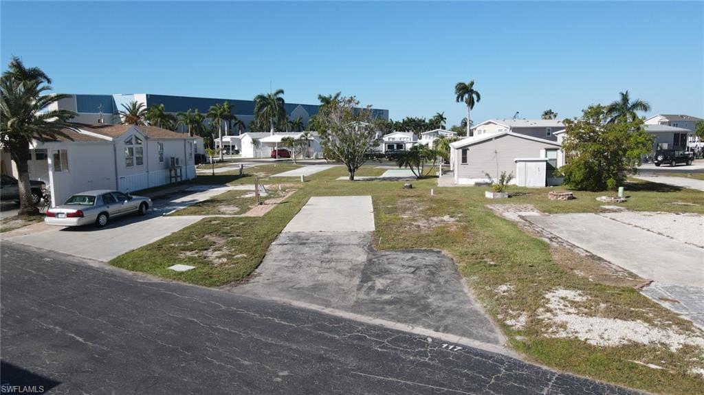**Lowest priced lot at Port Carlos Cove!** Location says it all! This non-waterfront vacant lot in Port Carlos Cove, a highly sought-after 55+ resident-owned co-op community, is just a short walk to Fort Myers Beach—offering the coastal lifestyle you desire without the premium price of waterfront property.  This is the best-priced lot currently available in Port Carlos Cove, making it an exceptional opportunity.  Design and build your ideal beach retreat with complete flexibility, while enjoying access to a private community boat ramp with quick entry to the Gulf—perfect for boating, fishing, and kayaking. Community amenities include a pool, clubhouse, shuffleboard, pickleball courts, and storage for boats, RVs, and trailers. The low $200/month HOA fee covers water, sewer, trash, and maintenance, providing one of the most affordable options for beachside living.  Ideally located within walking or biking distance to popular destinations such as Salty Sam’s Marina, Doc Ford’s Rum Bar, Parrot Key Caribbean Grill, Dixie Fish Co., Margaritaville Resort, and Times Square, you’ll enjoy convenient access to dining, entertainment, and the beautiful Gulf beaches.  Whether you're seeking a seasonal getaway, vacation home, or full-time residence, this is your chance to experience the best of Southwest Florida living!