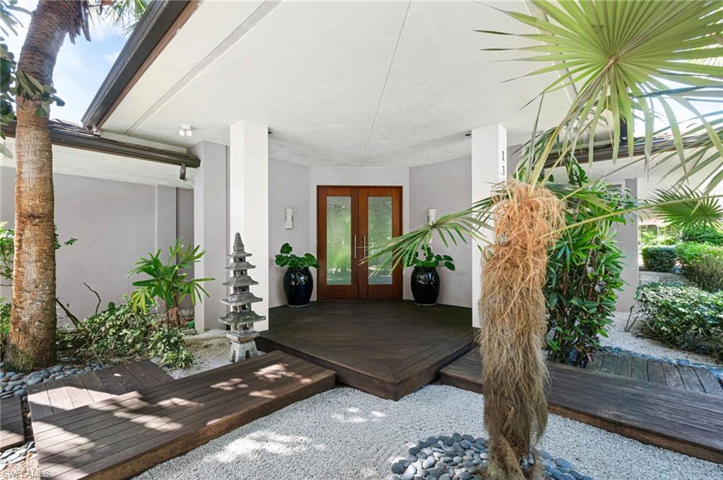 Situated on a highly coveted street within Pine Ridge Estates, this property is truly one of a kind. Offering unparalleled privacy on all four sides, 132 North Street is an oasis of tranquility. A golden bamboo cathedral-like space creates a captivating setting for outdoor entertainment. This property boasts the only true red clay tennis court in all of southwest Florida, with clay imported from Cremona, Italy. The court is maintained to top-notch conditions, providing a unique sporting experience. Stepping inside the house, you are greeted with an interior design that exudes elegance. Origami patterns within the ceiling designs incorporate Japanese flair. The flooring is covered with rare ipe wood creating a seamless flow between indoor & outdoor spaces. Large windows throughout the home allow natural light to flood in, creating a warm & welcoming atmosphere. With 4 bedrooms & 2 flexible additional rooms, the property's generous size provides a comfortable retreat for rest & relaxation.132 North Street offers a truly unique living experience. Prepare to be captivated by the enchanting atmosphere & the harmonious beauty that this property exudes.