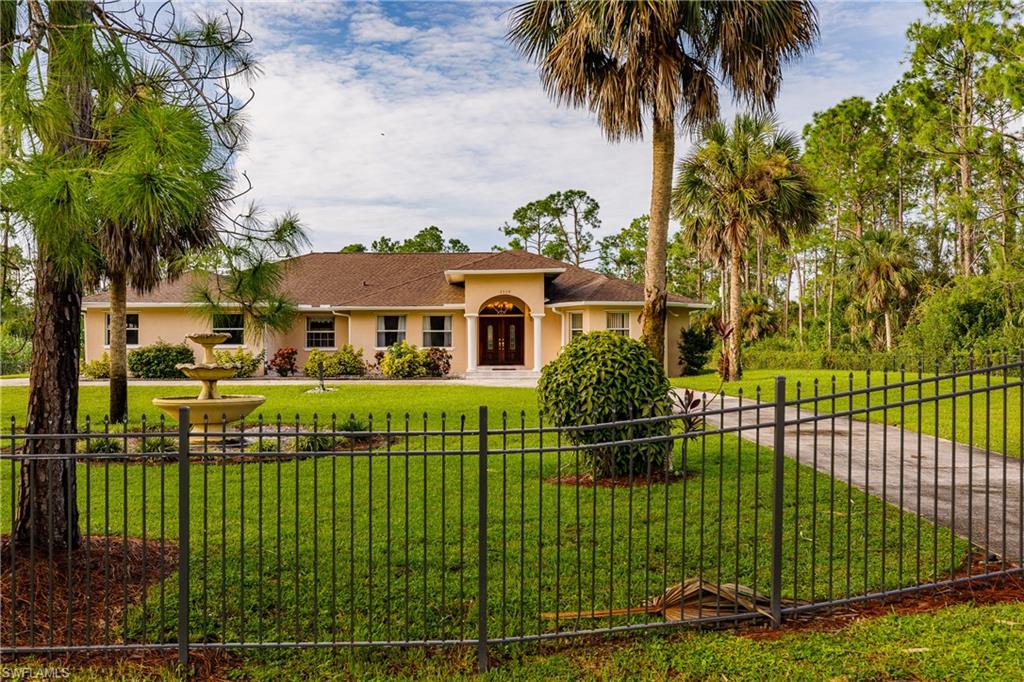 Don’t miss this opportunity to own this Gorgeous fully cleared and completely fenced 2.3 acre Estate Home that features over 3300 SQ FT, 4 Bedrooms, 3 Bathrooms, 2 Car Garage , formal dinning room + a media room/formal living room in the beautiful Golden Gate Estates, located under 1 mile from the new Publix. Featuring a spacious floor plan with open social areas and neutral décor. NEW ROOF 2018, NEW WOOD FLOORS IN BEDROOMS, 2 MASTER SUITES, WINDOWS GALORE, A COMPLETE HOME REVERSE OSMOSIS WATER SYSTEM, PROPERTY FULLY IRRIGATED, AND AUTOMATIC OPENING GATE SYSTEMS TO ENTER THE PROPERTY. This property is 2.3 acres fully fenced with plenty of room to add a pool and gated entrances in the front and the back!!! This on wont last schedule a showing today!