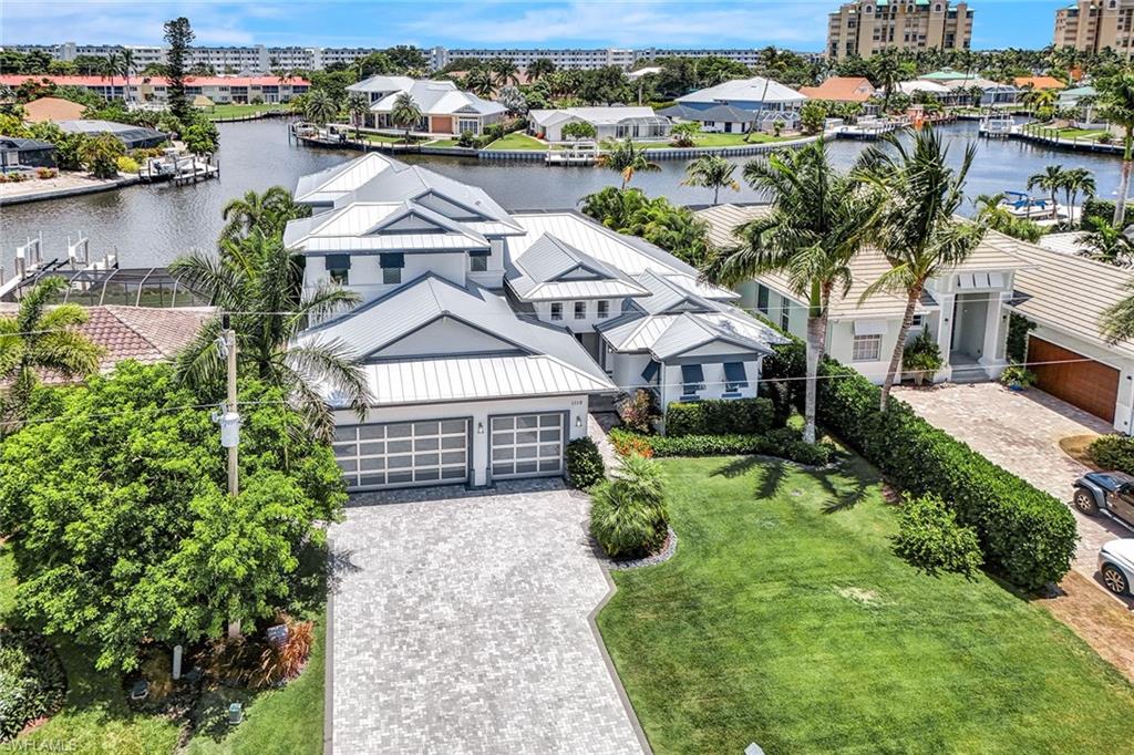 Stunning four-bedroom plus den, five-bath fully furnished custom-built home in the charming area of Old Marco. A boaters dream with fast water direct access to the Gulf of Mexico and gorgeous wide water views from your large private dock with two lifts. This gorgeous two-story residence has everything you need with a large open great room, custom gourmet kitchen, gas stove, separate built-in wall oven, wine cooler, quartz countertops, breakfast bar and sperate dining area. Primary suite retreat includes large walk-in closets, dual sinks, soaking tub and separate shower. There is a den, guest bedroom en-suite and pool bath on main floor, with a relaxing loft/family room and two additional bedrooms and baths on the second floor. Enjoy the beautiful tranquil views from your spacious screened lanai with pool, spa and summer kitchen. Impact windows and doors, with three-car garage. This exquisite home is must-see. Close to shops, restaurants and all Marco Island has to offer to start living in paradise today.